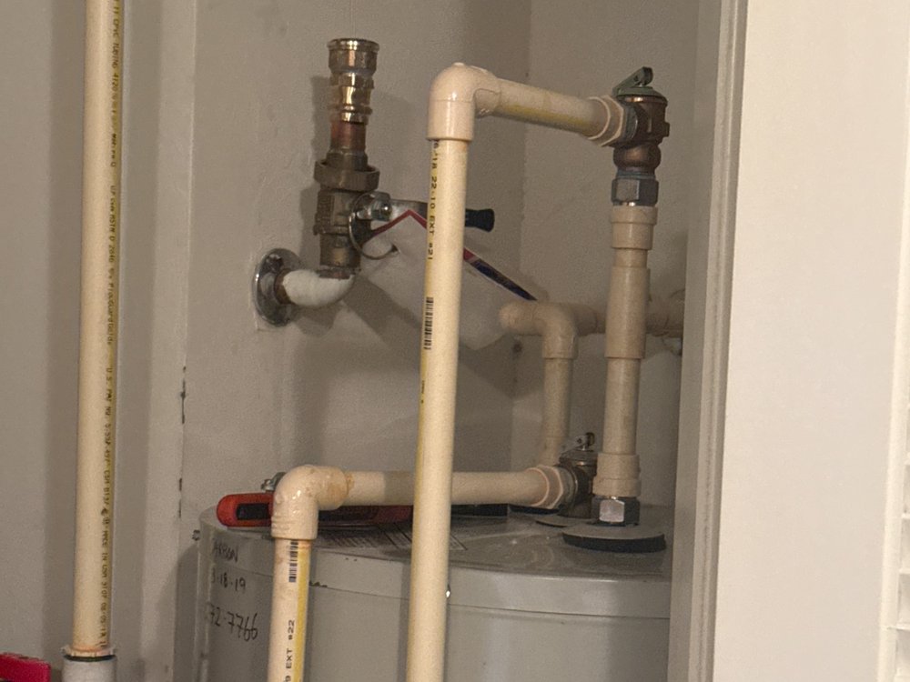 Water heater closet and Performance Plumbing and Propane service van, courtesy Father and Sons Home Watch